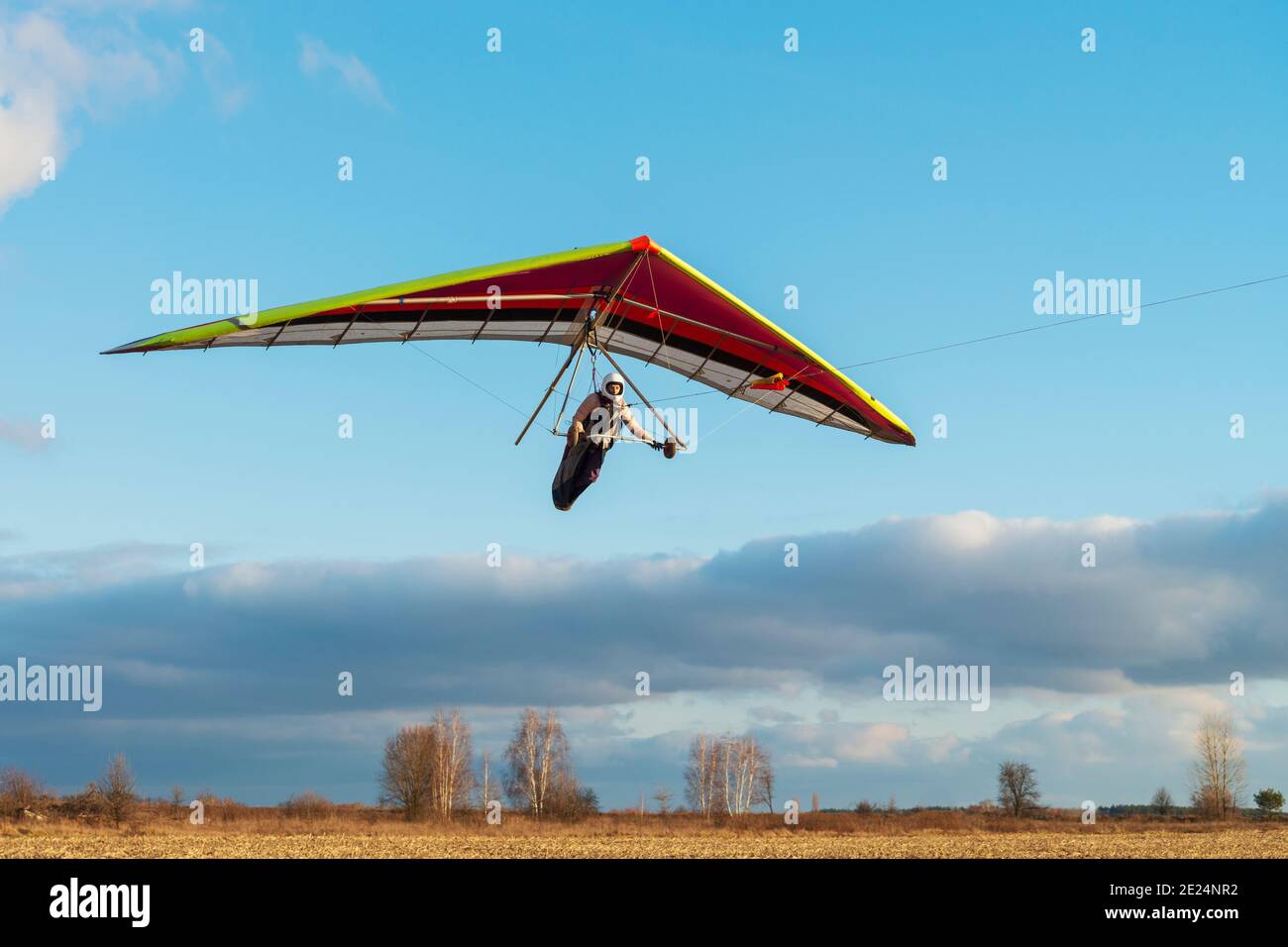 Brave girl student is mastering hang gliding sport. Extreme sports activity Stock Photo