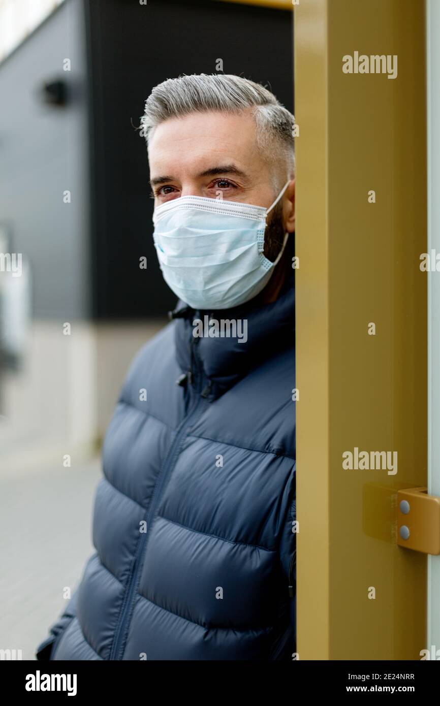 Man wearing face mask looking away Stock Photo