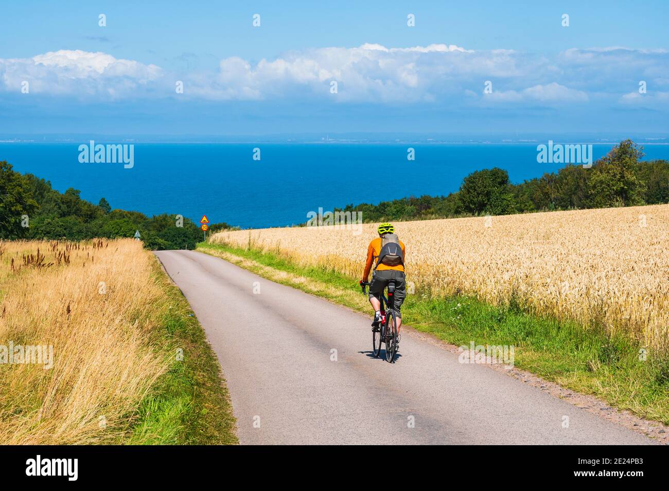Cyclist on country road Stock Photo