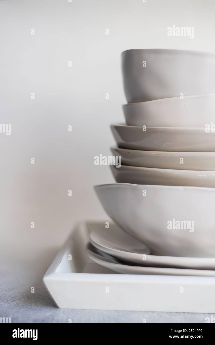 Stack of minimalist bowls and plates on a tray Stock Photo