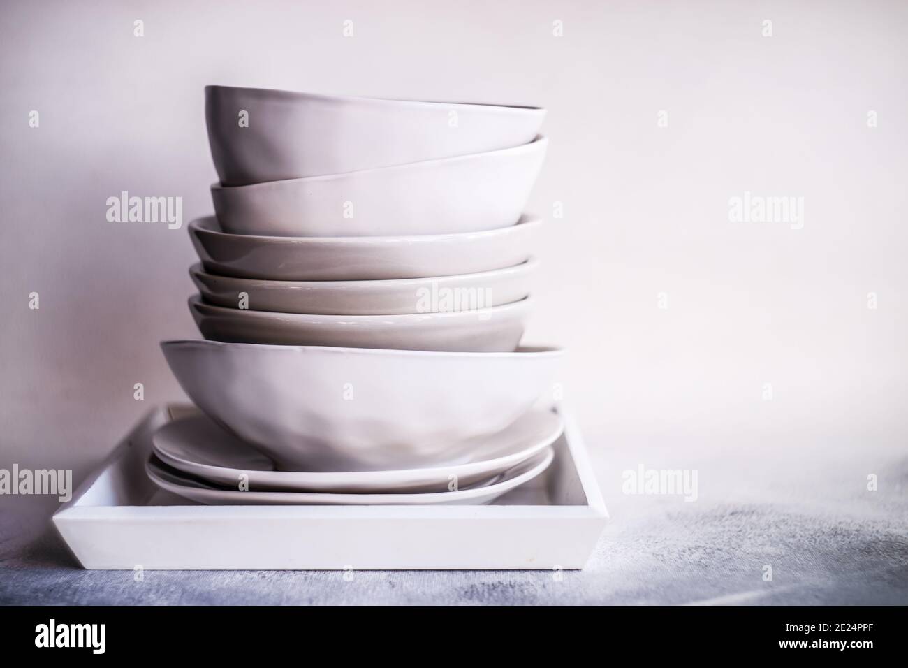 Stack of minimalist bowls and plates on a tray Stock Photo Alamy