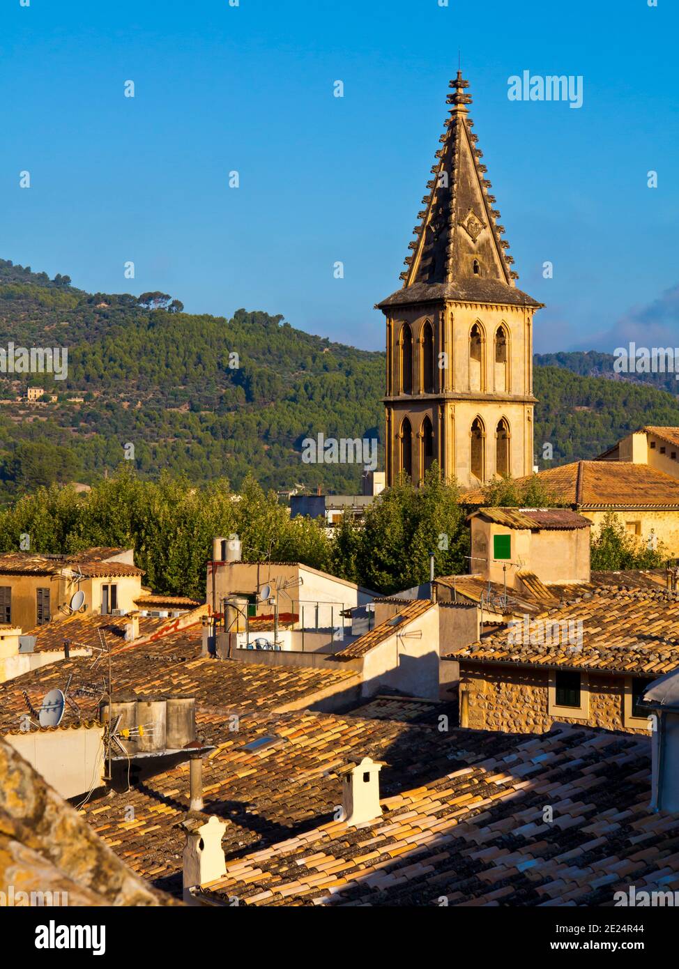 Early morning view across rooftops towards Esglesia de Sant Bartomeu a church in Soller in north west Mallorca Balearic Islands Spain Stock Photo