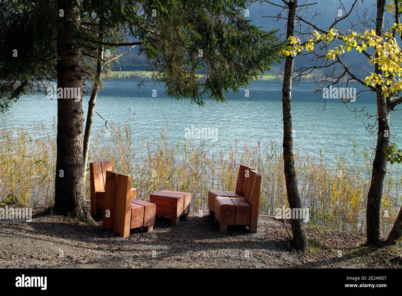 Austria, rest place with wooden seats on Weissensee lake in Carinthia Stock Photo