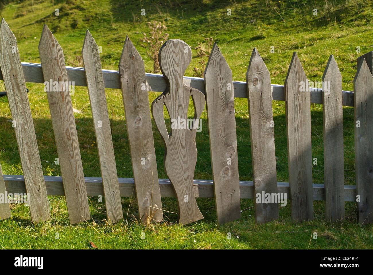 Austria, wooden fence with funny carving on Waisacher Alm in Carinthia Stock Photo