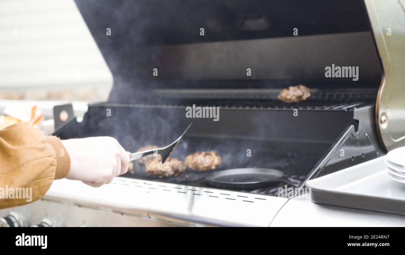 Cooking hamburger beef patties on a gas grill Stock Photo Alamy