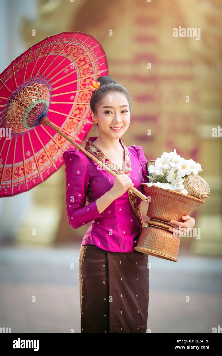 Portrait of a beautiful woman holding a basket with fresh flowers, Thailand Stock Photo