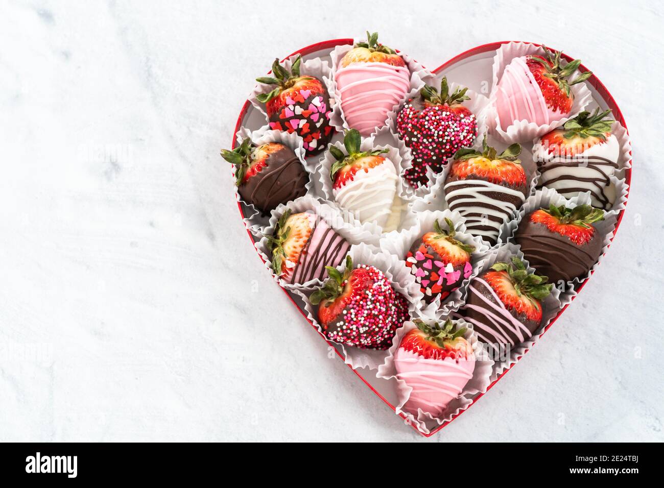 Heart shaped box with assorted chocolate covered strawberries on a