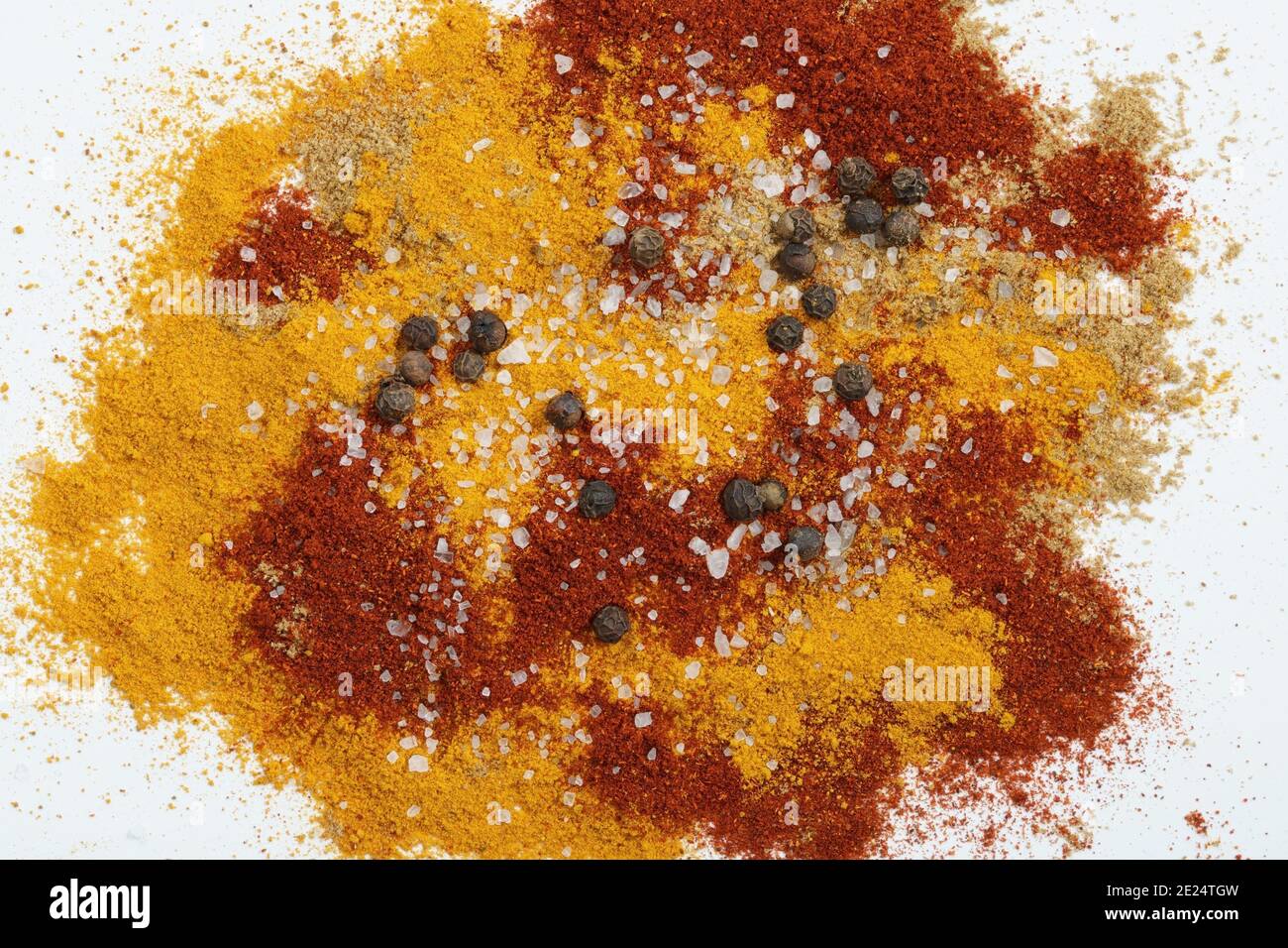 Five spices. Paprika, Turmeric, black pepper, salt and Cumin on a white