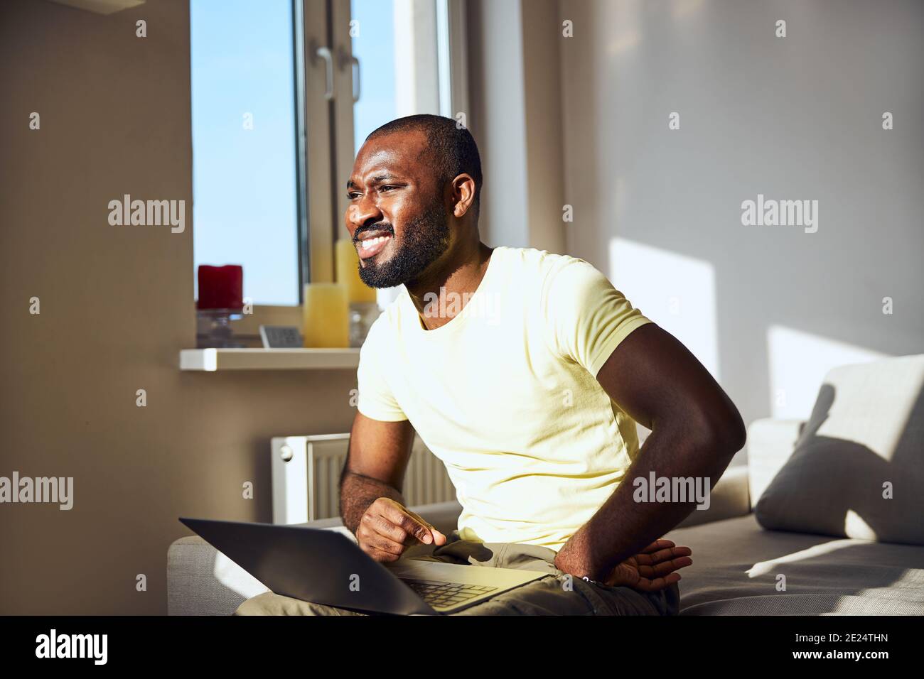Afro-American male is squinting from the sun Stock Photo