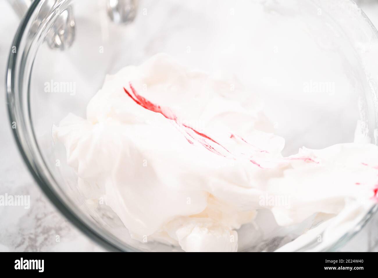 Mixing food coloring into the meringue to bake unicorn meringue cookies