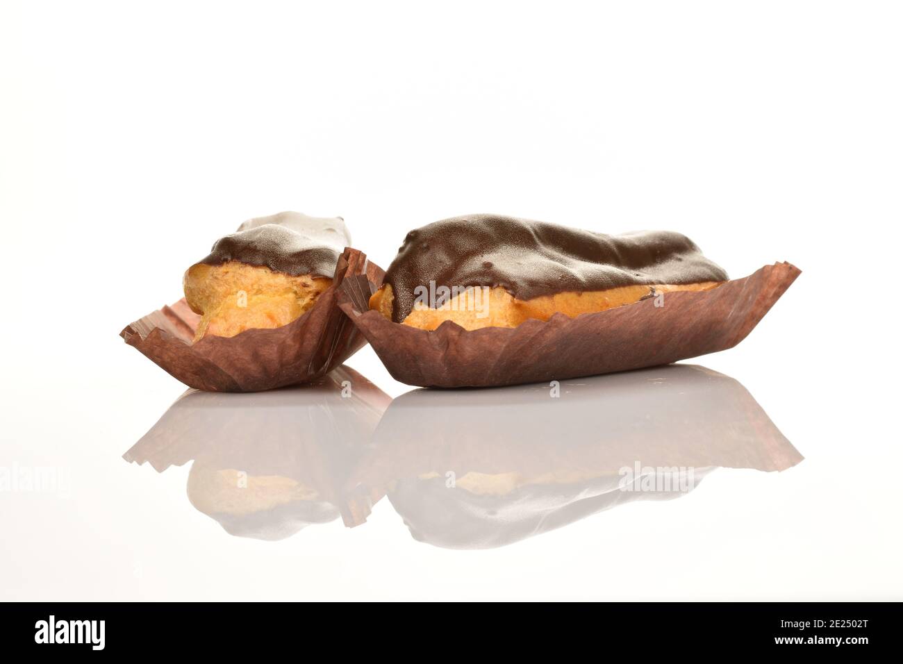 Two chocolate eclairs isolated on a white background. Stock Photo