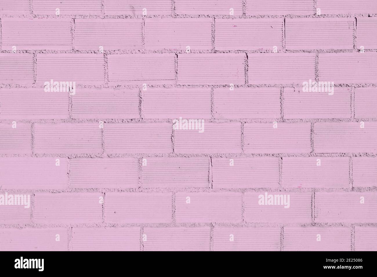 Pink colored old brickwall background Stock Photo