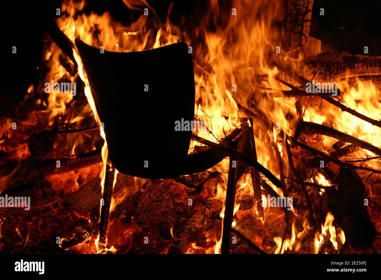 Black chair on fire with everything else burning next to it horror concept Stock Photo Alamy