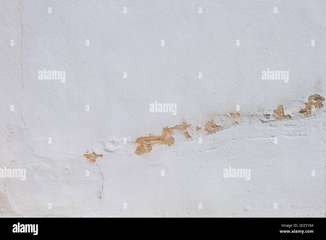 Old white wall with peeling paint Stock Photo