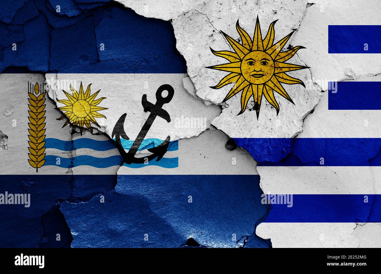 flags of Rio Negro Department and Uruguay painted on cracked wall Stock Photo