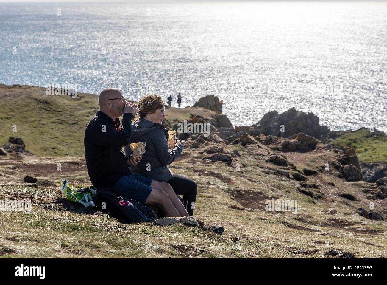 Autumn, coastal footpath walkers stop for a snack lunch Stock Photo