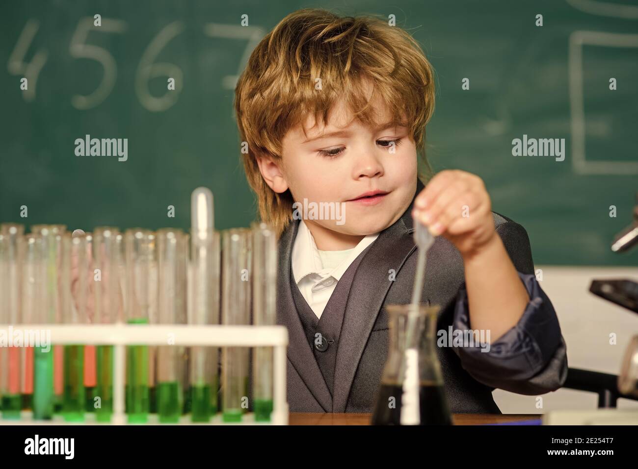 school kid scientist studying science. science experiments with