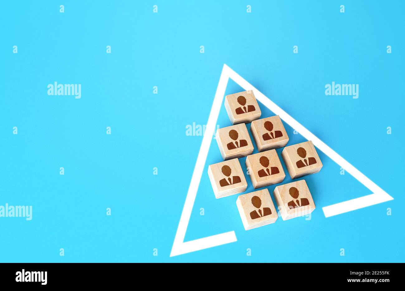 A team of people in a single formation in the shape of a triangle. Combining to achieve a goal. Unity. Team discipline, teamwork cooperation. Self man Stock Photo