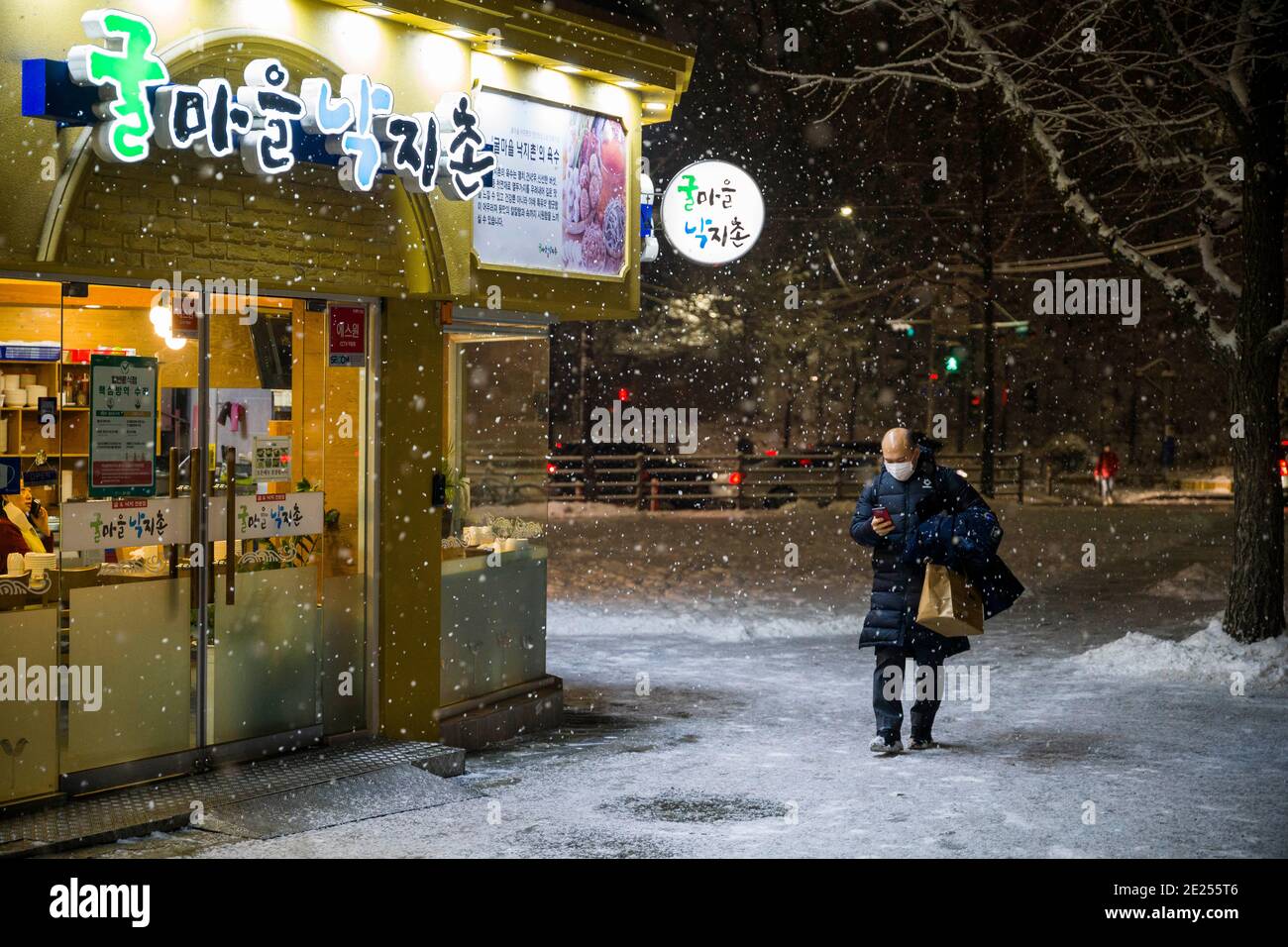 Seoul, Bucheon, South Korea. 12th Jan, 2021. A man walks in the snow in the Itaewon area of Seoul Tuesday, Jan. 12, 2020. Credit: Jintak Han/ZUMA Wire/Alamy Live News Stock Photo