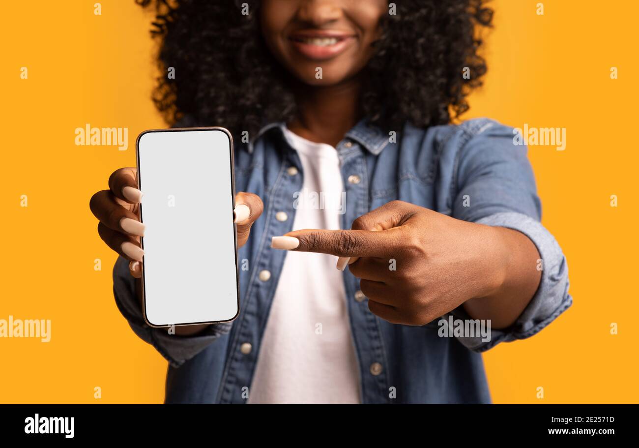 Black woman pointing at smartphone with empty screen Stock Photo - Alamy