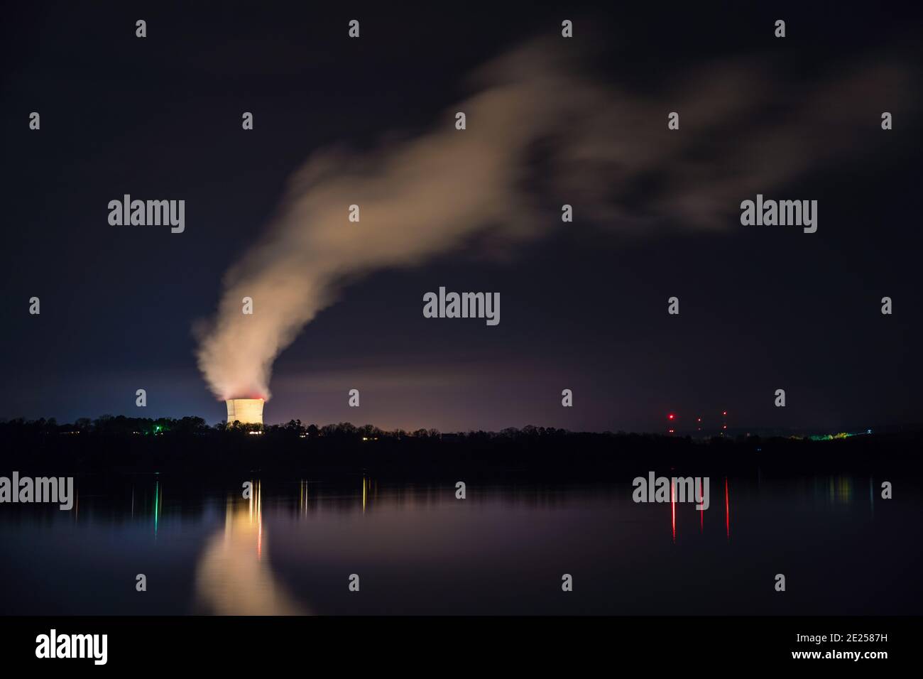 Russellville, AR/USA-March 1, 2020:  Night view of Arkansas Nuclear One, a pressurized water nuclear power plant with steam arising from cooling tower. Stock Photo