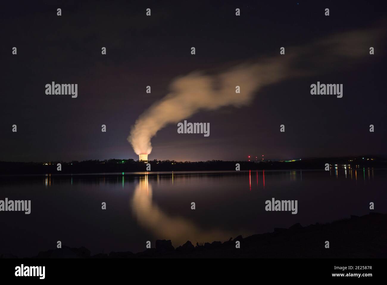 Russellville, AR/USA-March 1, 2020:  Night view of Arkansas Nuclear One, a pressurized water nuclear power plant with steam arising from cooling tower. Stock Photo