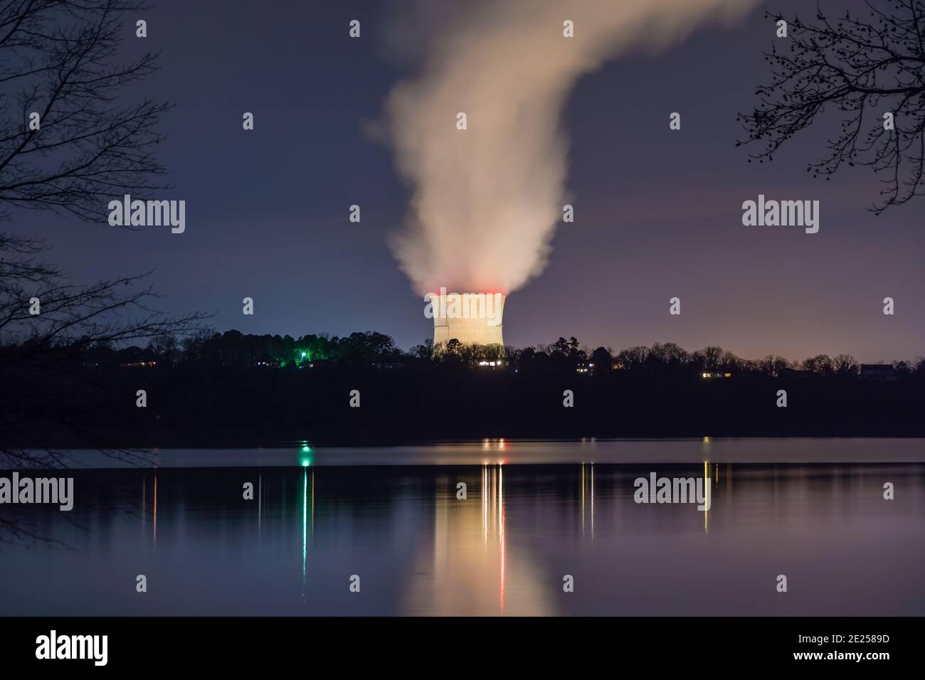 Russellville, AR/USA-March 1, 2020:  Night view of Arkansas Nuclear One, a pressurized water nuclear power plant with steam arising from cooling tower. Stock Photo