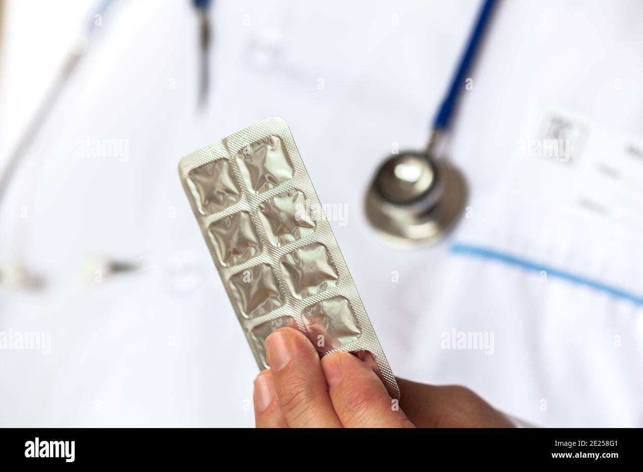 Doctor holding a blister packaging with medicine in his hand Stock Photo