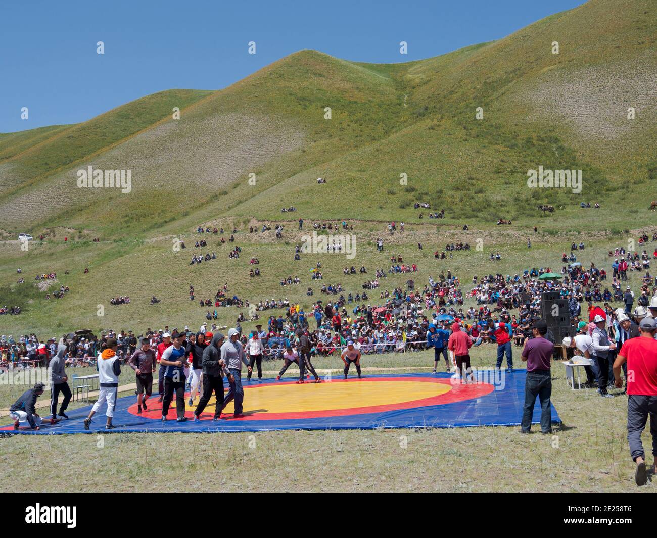 Kuresh, traditional Kyrgyz wrestling.   Folk and Sport festival on the Suusamyr plain commemorating Mr Koshomkul, a sportsman and folk hero of the las Stock Photo