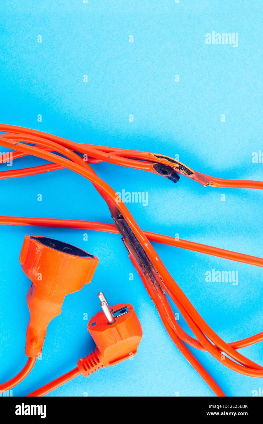 burnt electrical wire on blue background. Copy space Stock Photo Alamy