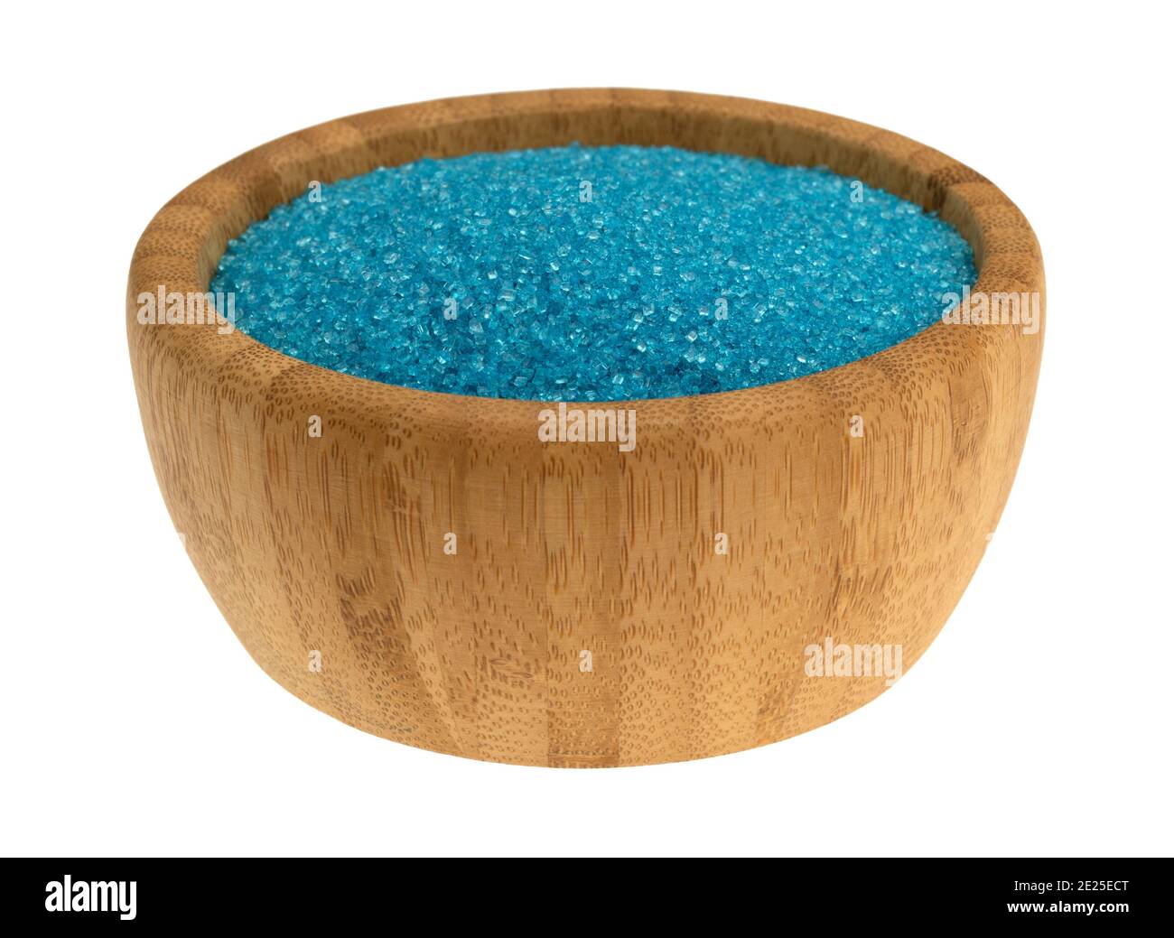 Portion of blue sanding sugar in a small wood bowl isolated on a white background. Stock Photo