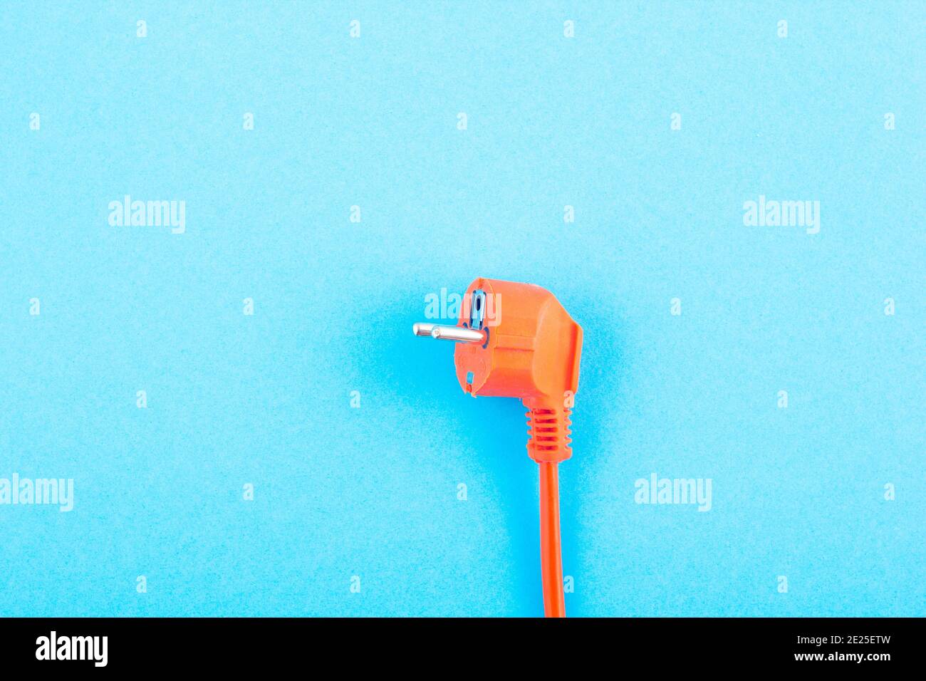 Orange electrical wire on blue background. copy space Stock Photo Alamy