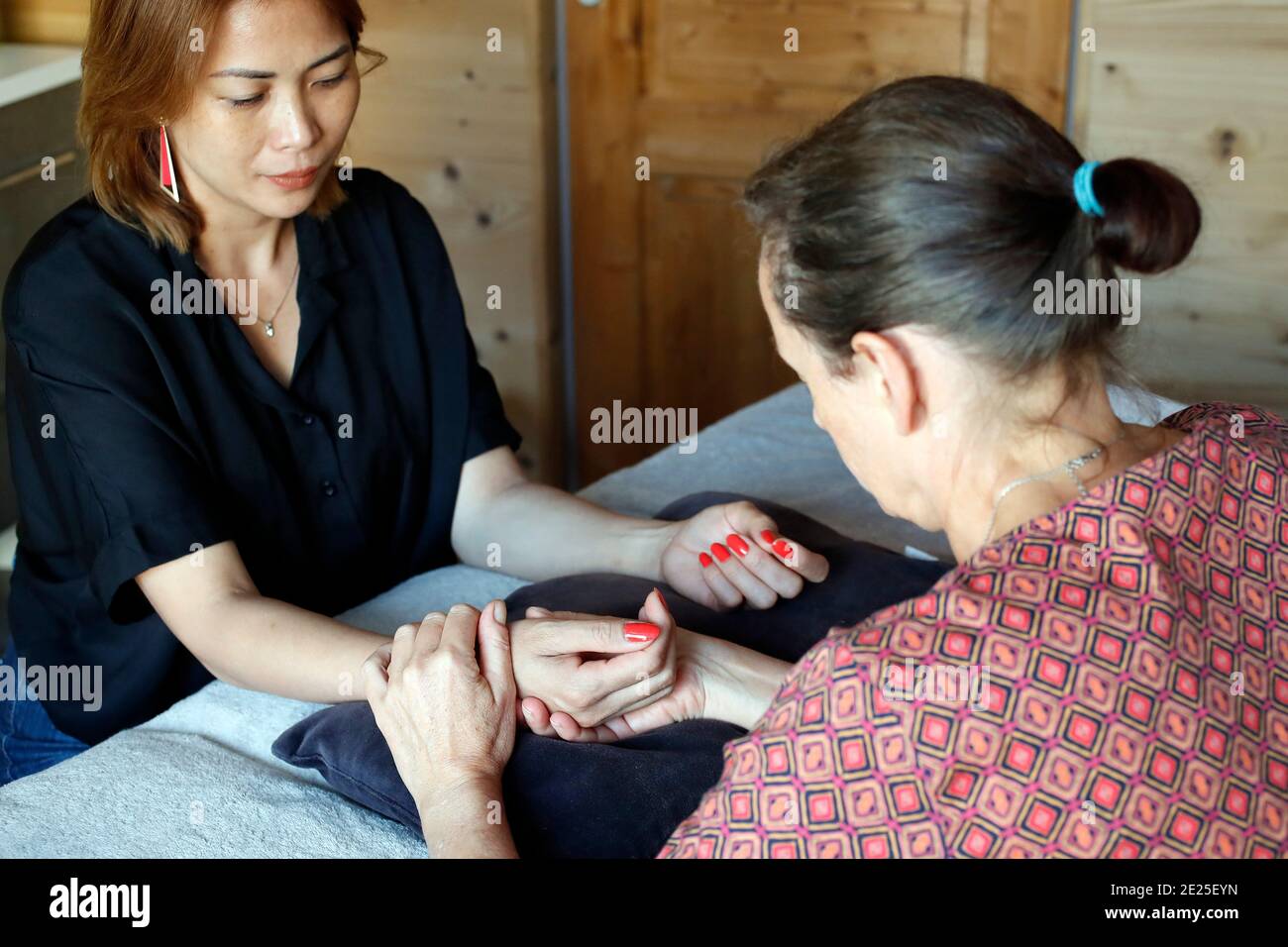 Traditional chinese medecine. Practitioner checking pulse of young