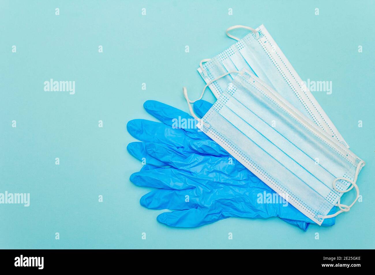 Surgical protection masks and gloves isolated on light blue background ...