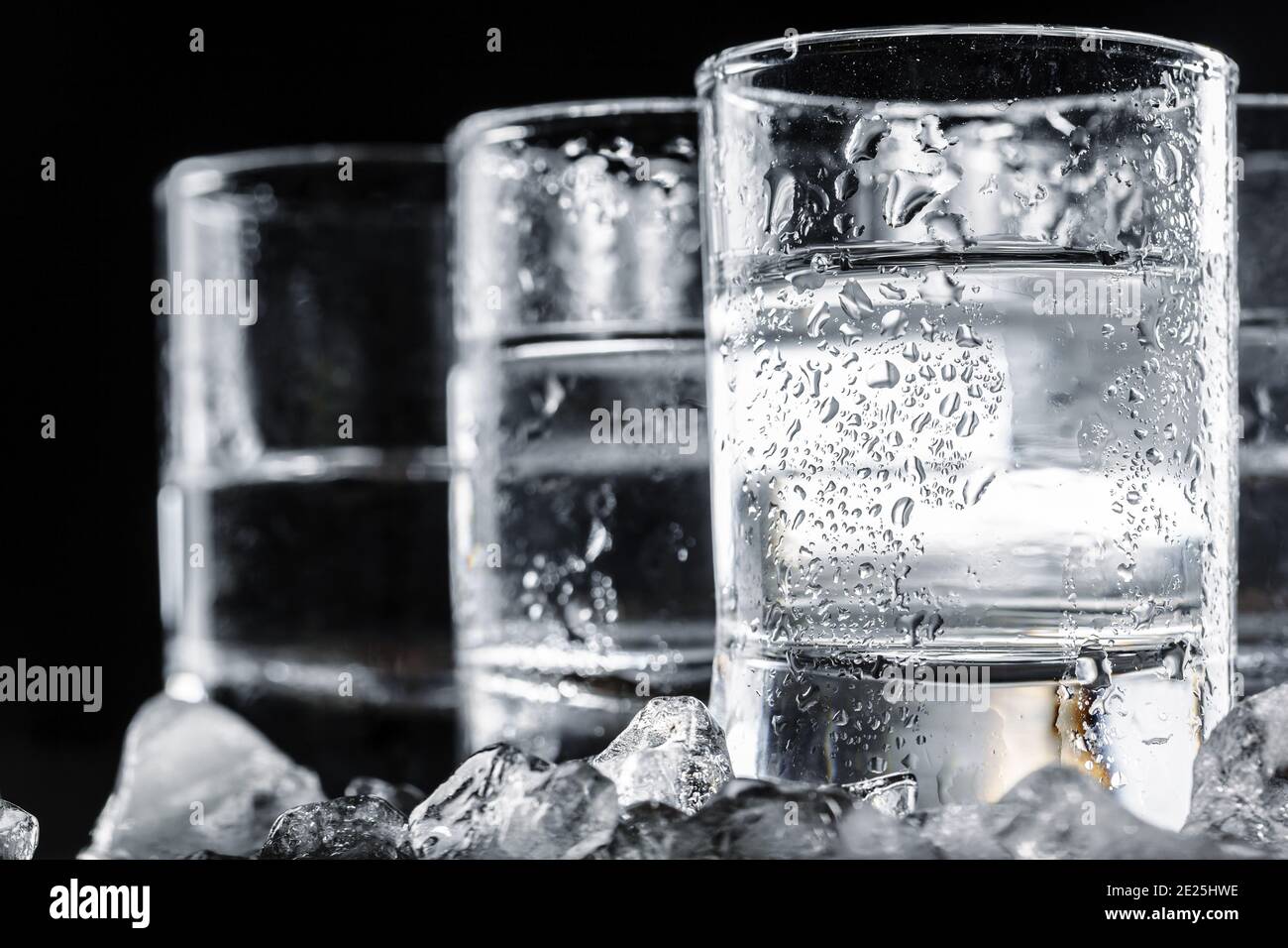 Vodka in shot glasses on rustic wood background Stock Photo - Alamy