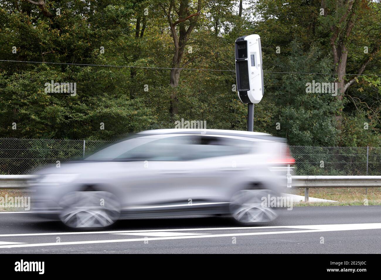 Car speeding past a speed camera in Eure, France. Stock Photo