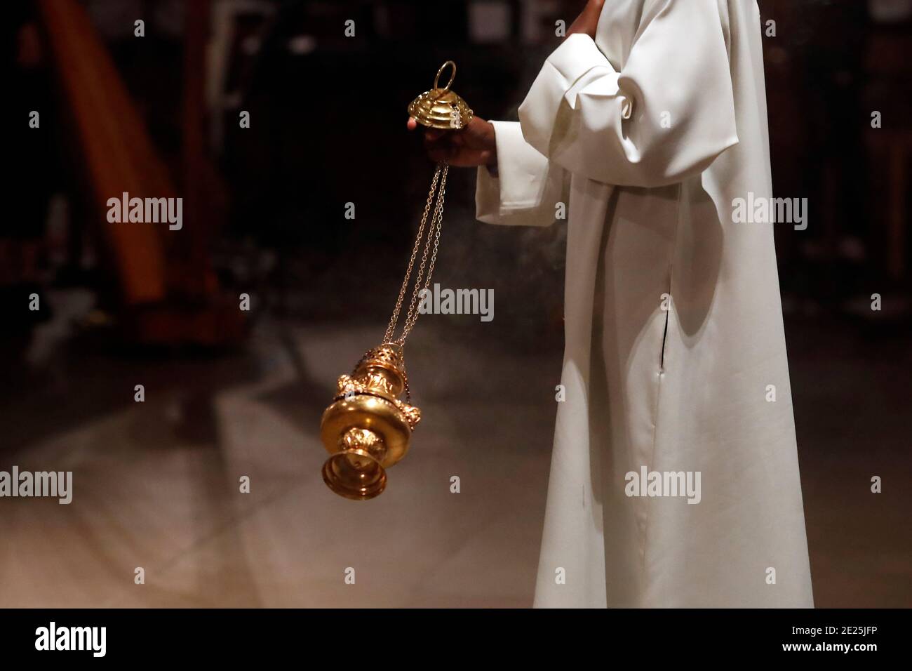 Basilica of Our Lady of Geneva.   Catholic mass. Altar boy with thurible. Stock Photo