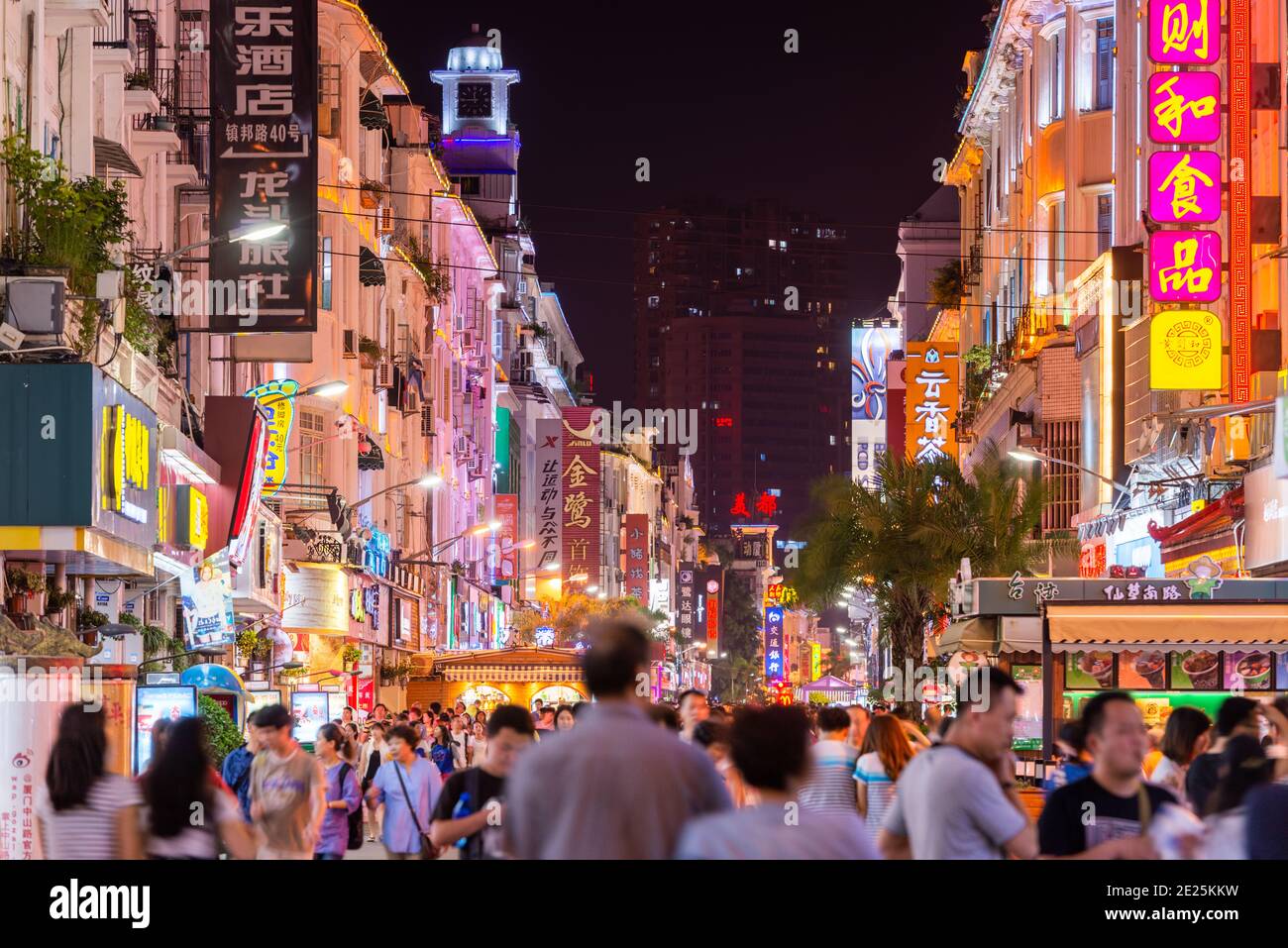 XIAMEN, CHINA - JUNE 11, 2014: Pedestrians walk on Zhongshan Road at night. The road is the main commercial street in Xiamen and parts have been fully Stock Photo