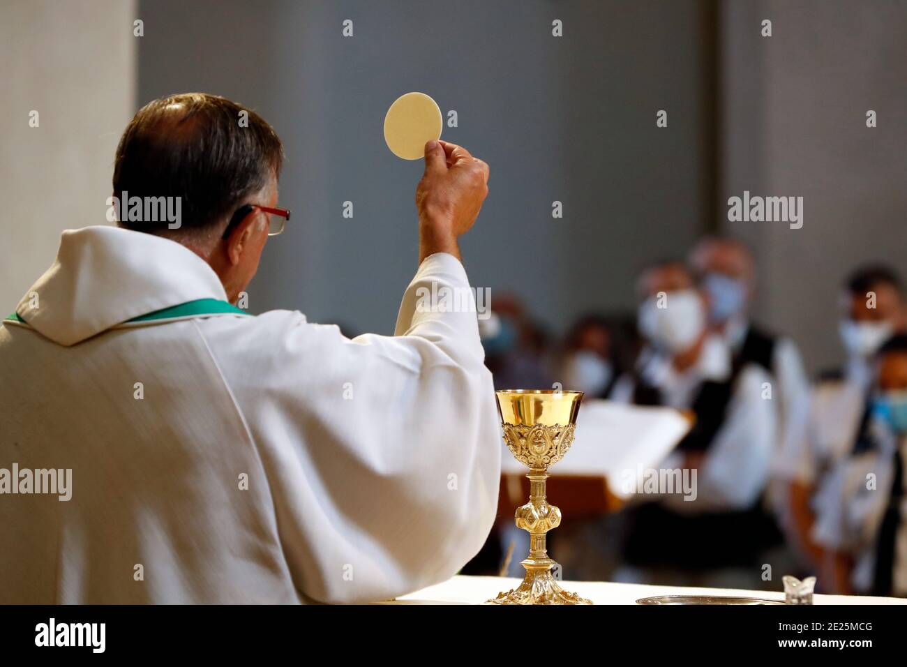 Catholic church during covid-19 epidemic. Sunday mass. Holy Communion.  Saint Gervais. France. Stock Photo