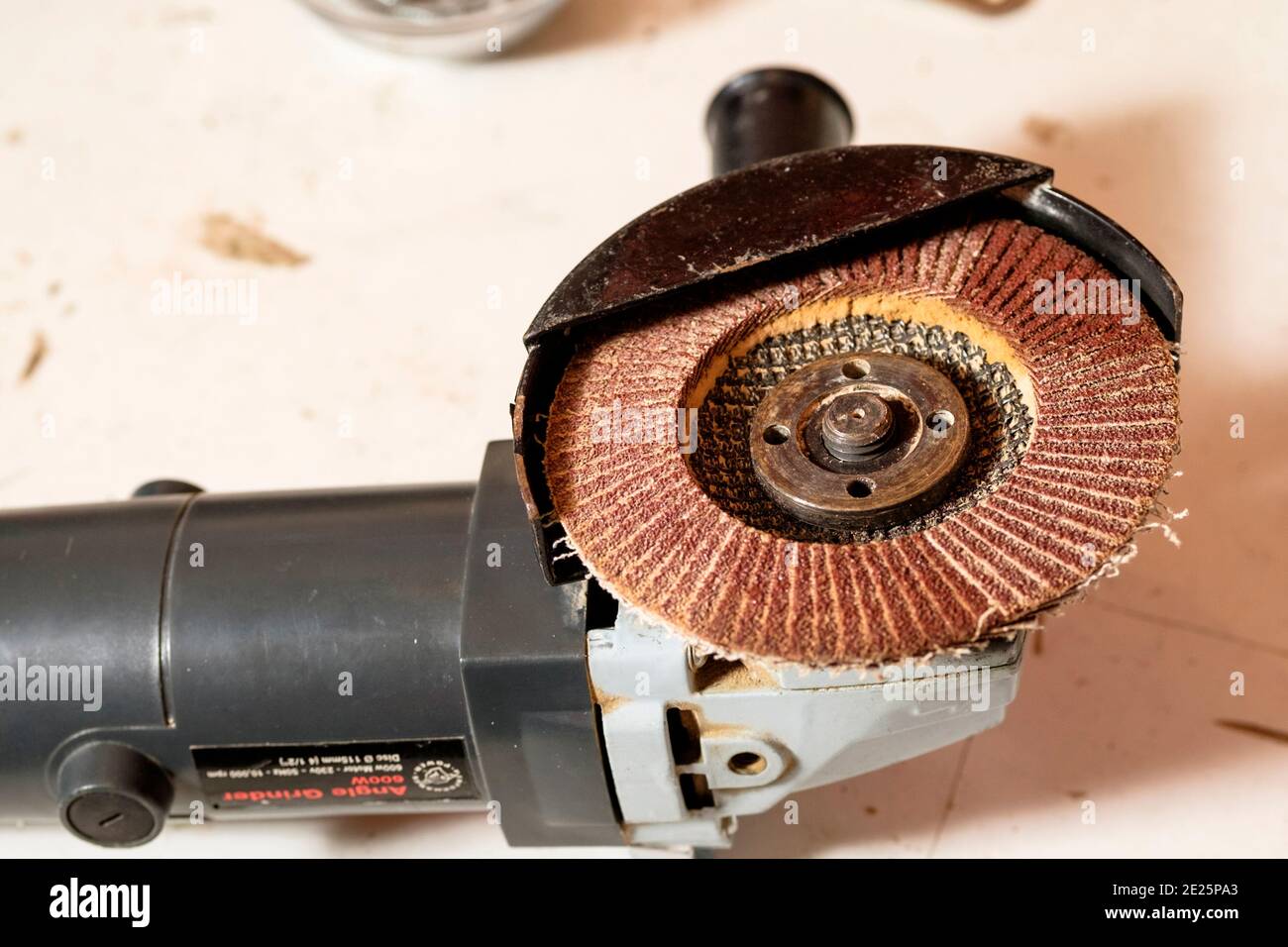 A flapy sanding disk mounted on a handheld angle ginder. Stock Photo