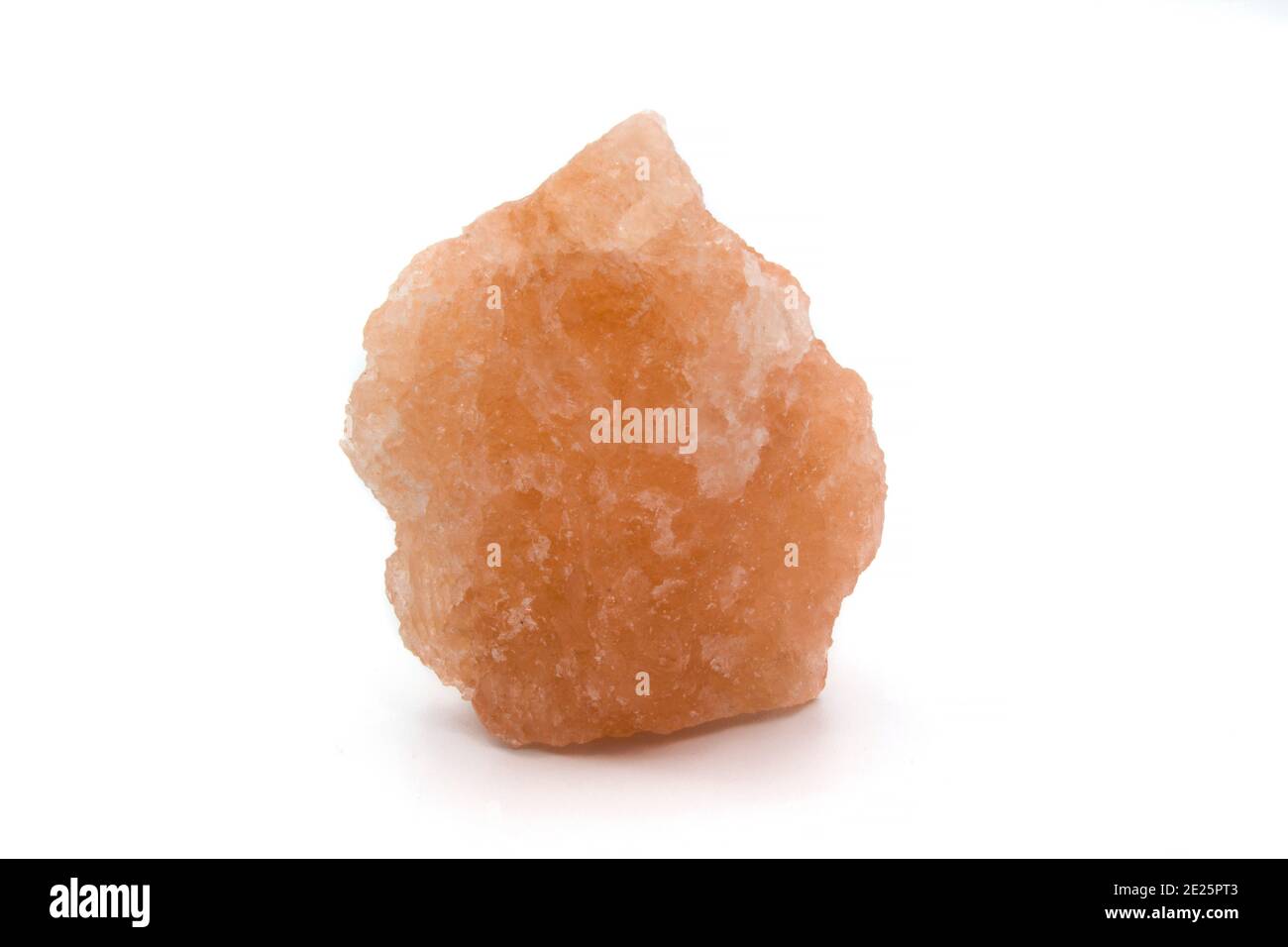 Lump of orange rock salt (isolated) on white Stock Photo