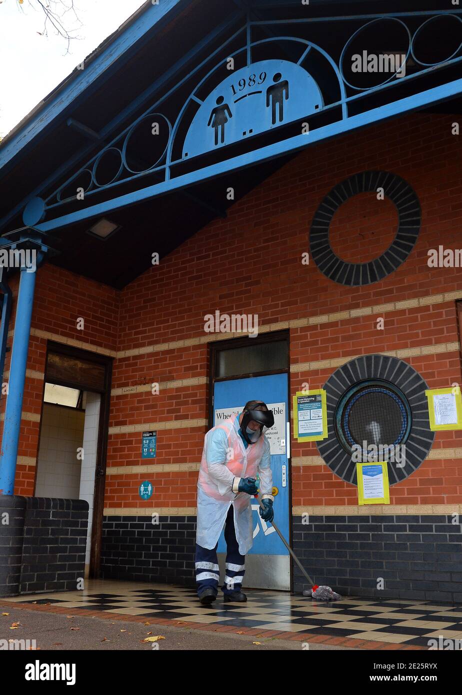 A City Council worker cleans public toilets wearing personal protective equipment in Leicester