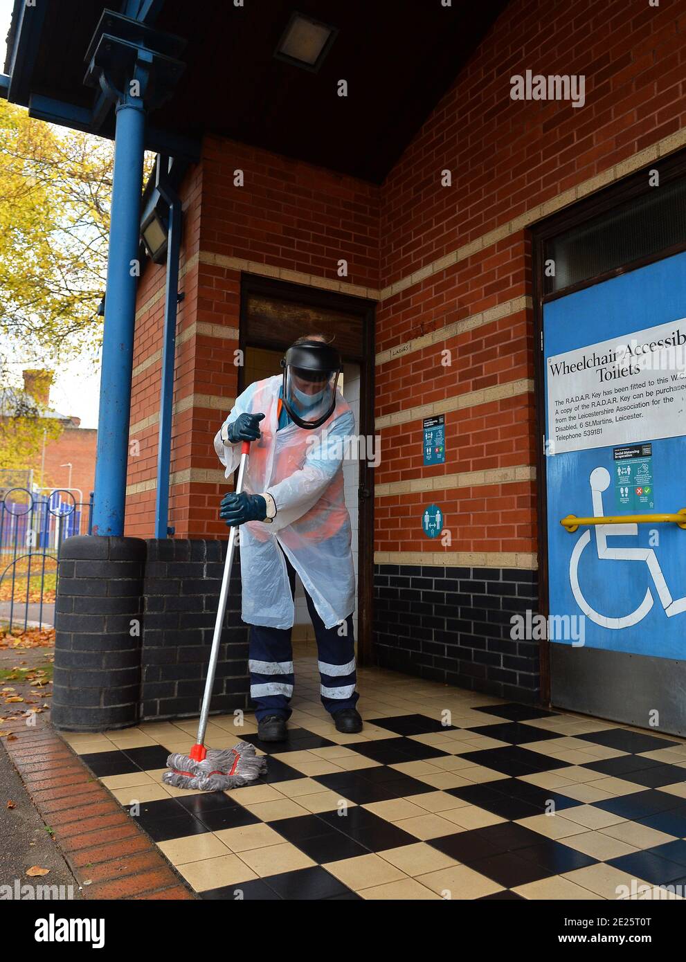 A City Council worker cleans public toilets wearing personal protective equipment in Leicester