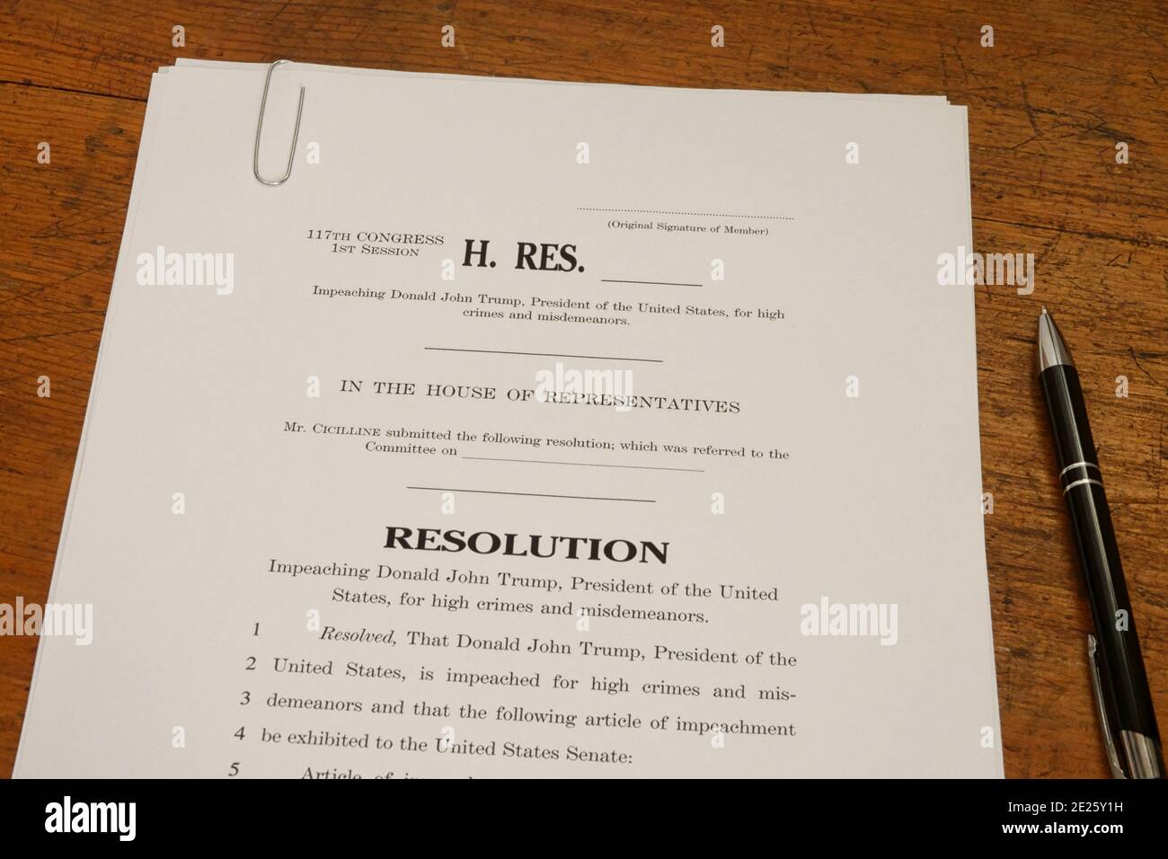 Washington, D.C. / USA - Jan. 11, 2021: A House of Representatives draft resolution for impeaching Donald John Trump is shown on a wood desk. Stock Photo