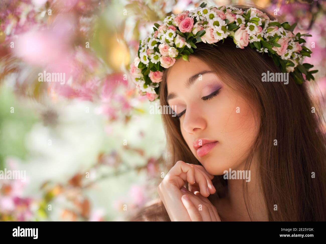 Beautiful girl with closed eyes and a flower crown Stock Photo - Alamy