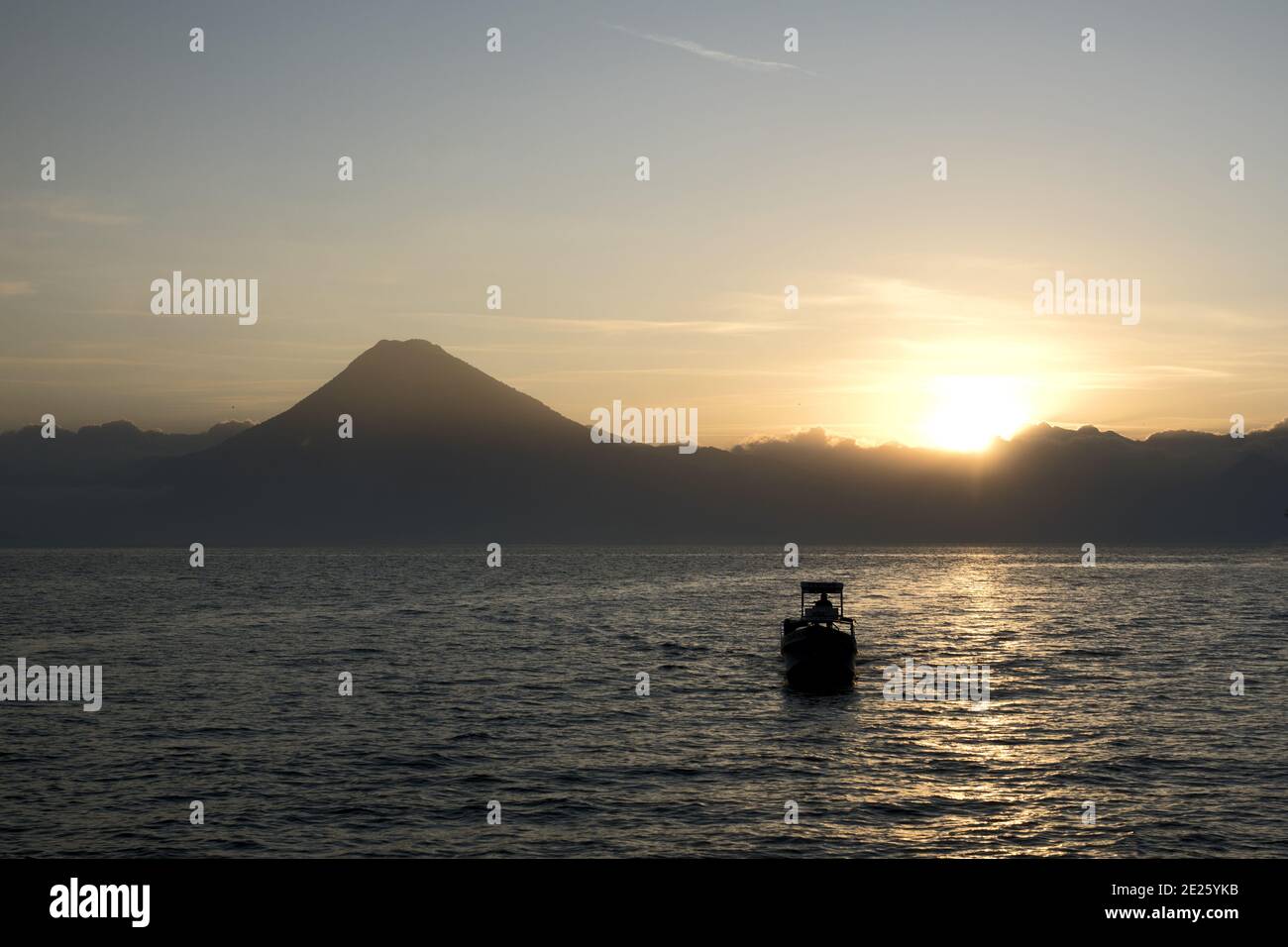 Guatemala, Central America: Lake Atitlán (Atitlan) with volcanos - sunset with boat Stock Photo