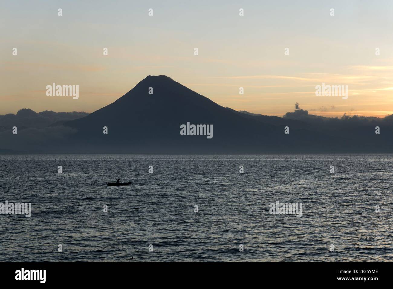 Guatemala, Central America: Lake Atitlán (Atitlan) with volcanos - sunset with boat Stock Photo
