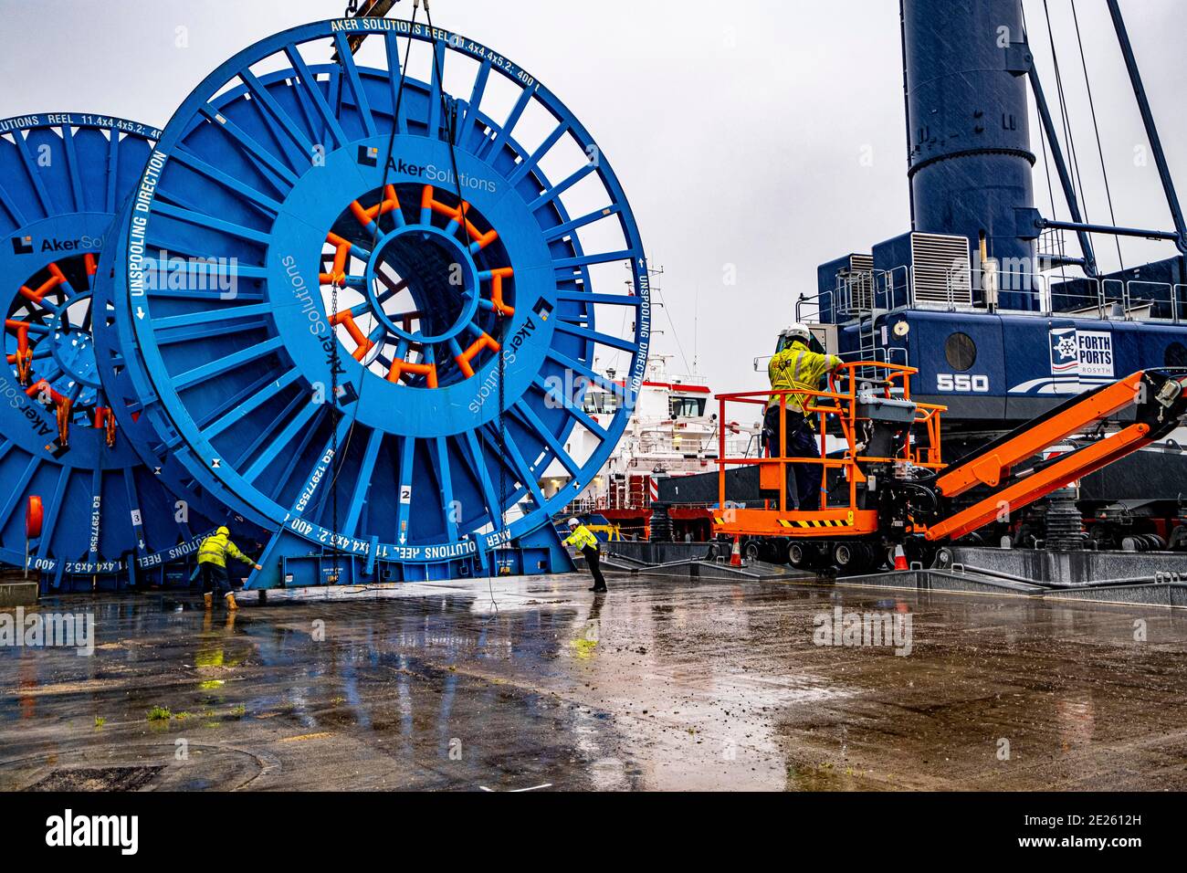 Large North Sea  reels being unloaded at dockside Stock Photo