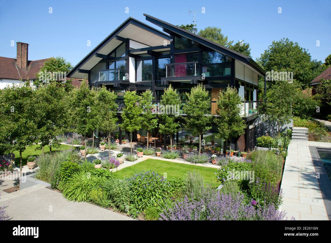Rear elevation of Huf Haus with trees and landscaped garden Stock Photo