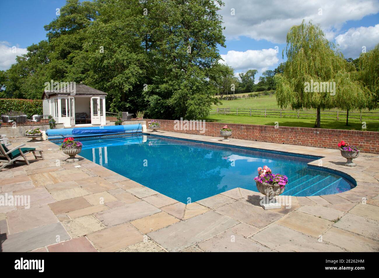 Outdoor private rectangular swimming pool with steps and pool hut Stock Photo